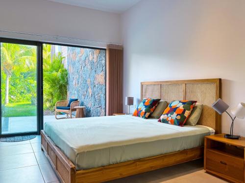 a bedroom with a large bed and a large window at Blue Zebra - T4 Oasis - Rivière, Mer et Piscine in Rivière Noire