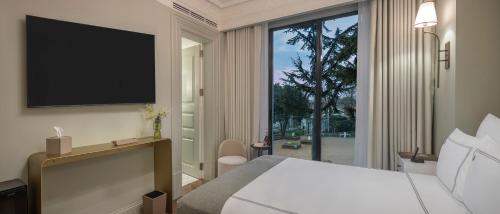 a bedroom with a bed and a large window at Komana Hotel Binbirdirek in Istanbul