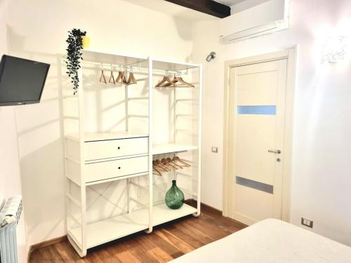 a white closet with a white shelving unit at Vibes 5terre in Riomaggiore