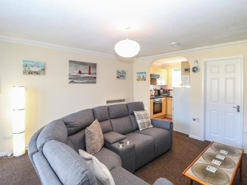 a living room with a couch and a table at No 108 Waterside in Lowestoft