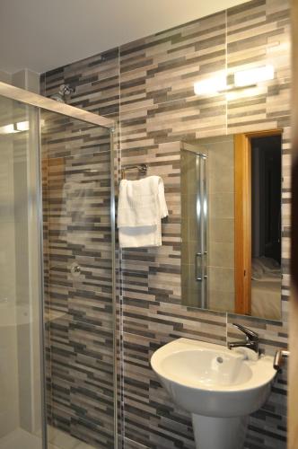 a bathroom with a sink and a mirror at Pons Minea in Portomarin