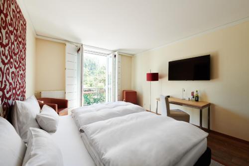 Postel nebo postele na pokoji v ubytování Hotel Weitzer Graz - Centre of Graz