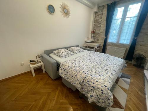 a bedroom with a bed and a clock on the wall at Azur Studio Riviera Stay in Antibes