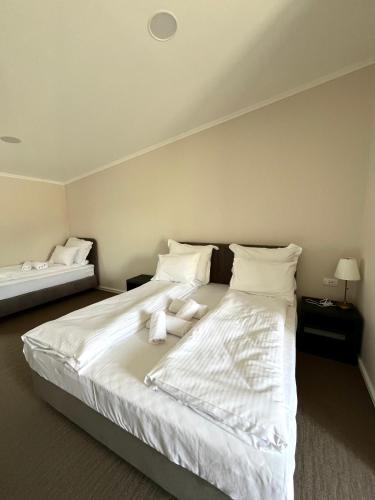 a bedroom with a large bed with white sheets and pillows at Conty in Vršac