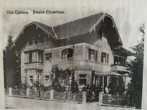 an old black and white photo of a house at Villa Theresia in Benediktbeuern