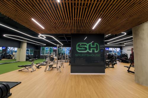 a gym with treadmills and elliptical machines at Zaliakalnio terasos apartamentai in Kaunas