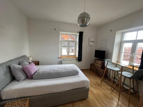 a bedroom with a bed and a glass table at Villa Theresia in Benediktbeuern