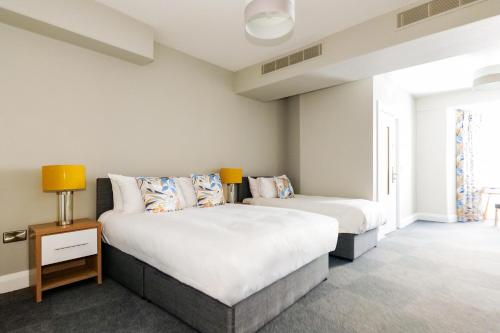 a bedroom with two beds and a window at The Central House Hotel Clifden in Clifden