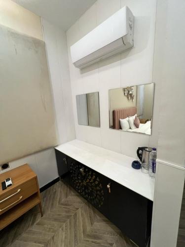 a kitchen with a white counter and a mirror at Vorano Boutique Hotel Islamabad in Islamabad