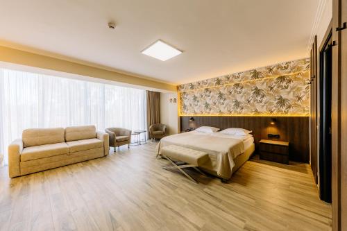a hotel room with a bed and a couch at Mayak Resort in Kyiv