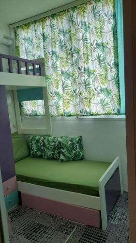 a bunk bed with a green seat in a room at holidays Nea Peramo in Nea Peramos