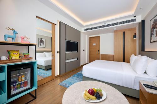 a hotel room with a bed and a fireplace at Iris Sarovar Portico in Gurgaon