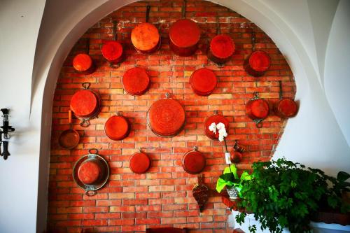 a brick wall with copper pots and pans on it at Da Gelsomina in Anacapri