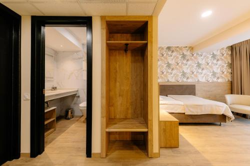 a bedroom with a bed and a bathroom at Mayak Resort in Kyiv