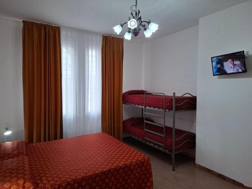 a bedroom with two bunk beds and a window at Lucazione Turistica in Mestre