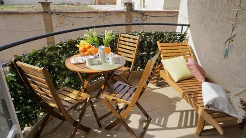 a table and chairs on a balcony with fruit on it at Апартамент Деа - Apartment Dea in Byala