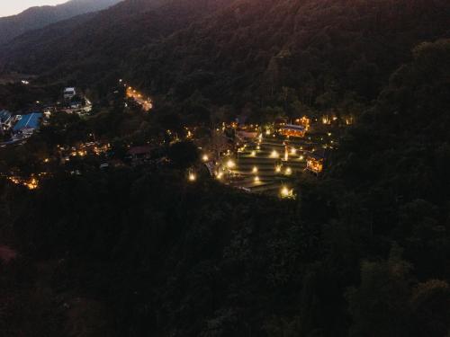 an aerial view of a town in the mountains at night at บ่อเกลือ วิว รีสอร์ท in Ban Pha Khap