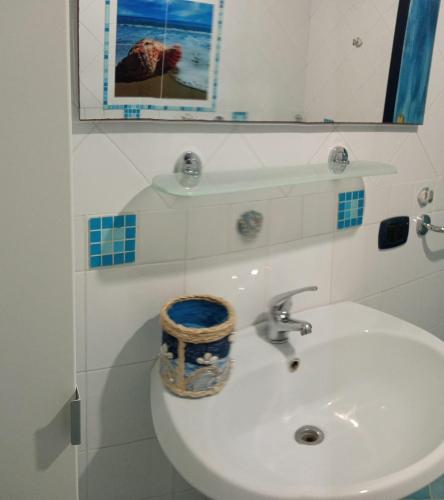 a bathroom with a white sink and a mirror at Casa Ancora in Massa Lubrense
