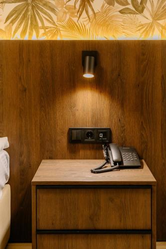 a telephone sitting on a wooden table in a room at Mayak Resort in Kyiv