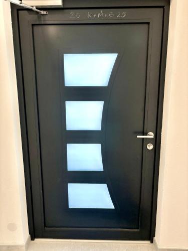 a black door with a sign on it at Gästehaus Seeblick Penthousewohnung in Seekirchen am Wallersee