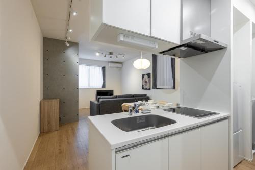 a kitchen with a sink and a living room at TOKYO SHIBA Retreat 3427 in Tokyo