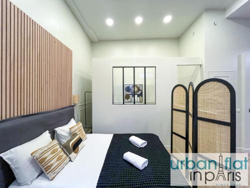 a bedroom with a bed with two pillows on it at 05 - Parisian Design Loft in Paris