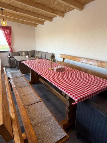 a dining room with a red and white checkered table at Kuća za odmor Villa Kovačević in Bihać