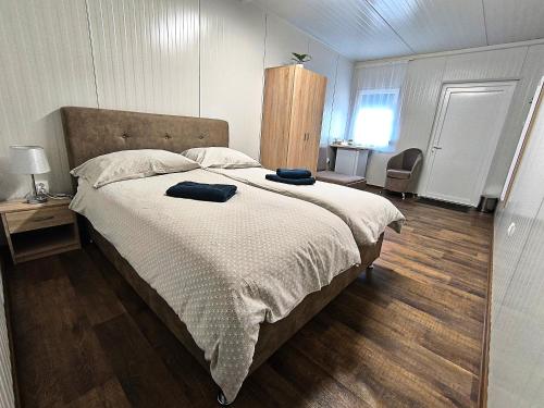 a bedroom with a large bed with two pillows on it at Szusz Szállás in Debrecen