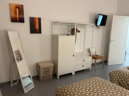 une chambre avec un lit, une commode et un miroir dans l'établissement Marchese di Montrone 126, à Bari