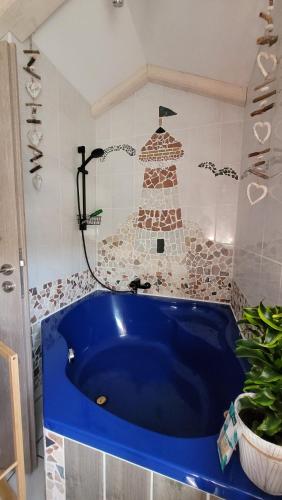 a blue tub in a bathroom with a fireplace at Biggy's Apartment in Selb