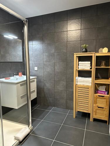 une salle de bain avec un lavabo et un miroir dans l'établissement Torriciola location Genovese, à Ajaccio