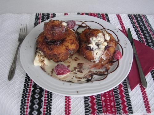 a plate of food with chicken on a table at Pension Perla Bucovinei in Voronet