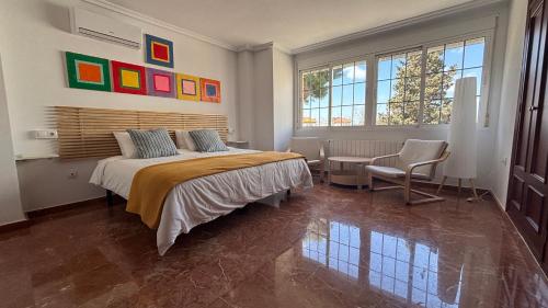 a bedroom with a bed and a table and chairs at Casa Frijol 20metres from the beach in Los Alcázares