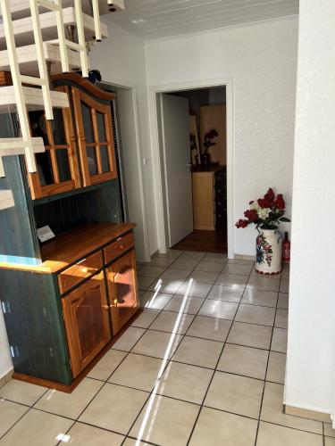 a living room with a cabinet and a tile floor at Bliede RE05 in Sögel
