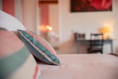 two pillows sitting on top of a bed at DOMAINE FORVENT in Saint-Julien-de-Peyrolas