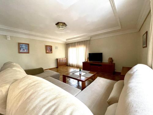 a living room with a couch and a table at Home Campoamor in Orihuela Costa