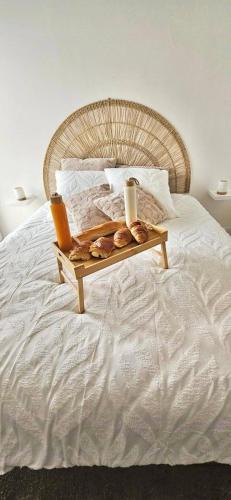 a tray of pastries sitting on a bed at Gîte le temps d'un instant in Samer