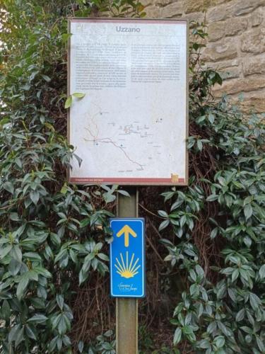 a sign in front of a bush with a sign at Castle apartment Aga in Uzzano