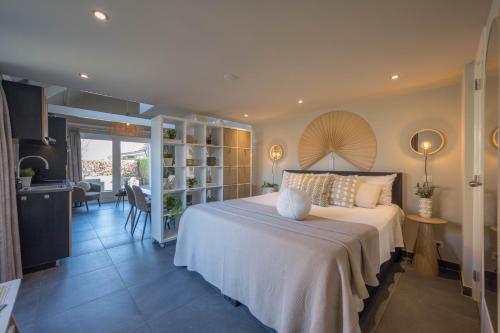 a bedroom with a bed and a living room at De Grote Stern in Groet