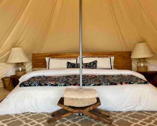 Bett in einem Zelt mit 2 Lampen und einem Tisch in der Unterkunft Escápate a un bosque mágico Citlalapa in Xico