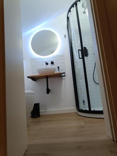a bathroom with a sink and a mirror at Castle apartment Aga in Uzzano