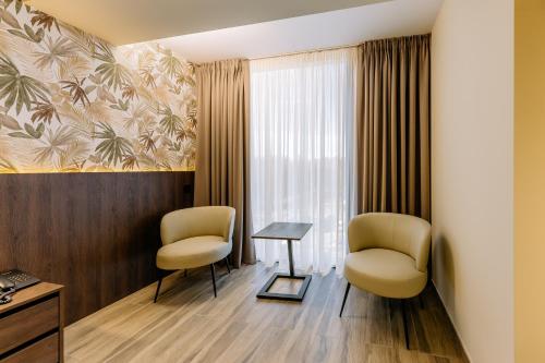 a room with two chairs and a table and a window at Mayak Resort in Kyiv