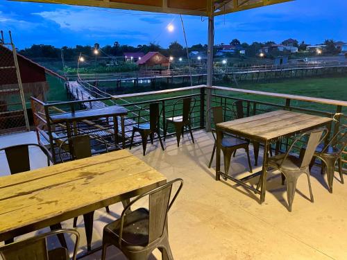 a group of tables and chairs on a roof at BK Bungalows in Kampong Cham