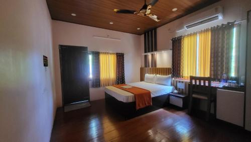 a hotel room with a bed and a bathroom at Bell Farms and Resorts in Munroe Island