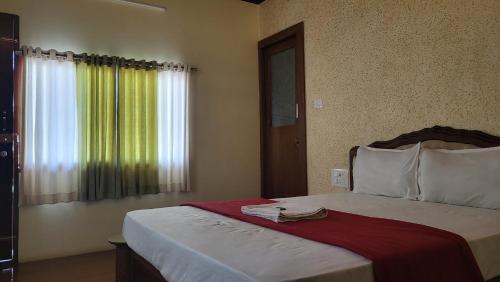 a bedroom with a large bed with a window at Bell Farms and Resorts in Munroe Island
