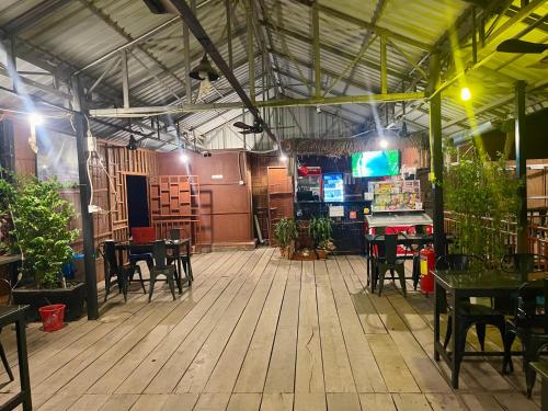 a patio with tables and chairs in a restaurant at BK Bungalows in Kampong Cham