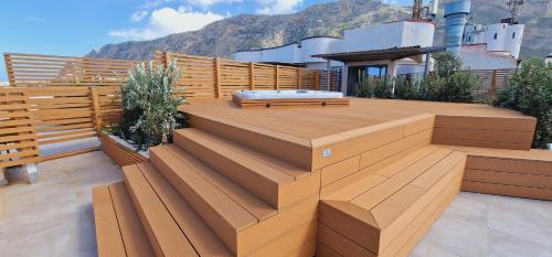 a deck with a bed on top of a house at Saracen Sands Hotel & Congress Centre - Palermo in Isola delle Femmine