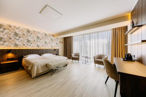 a hotel room with a bed and a table and chairs at Mayak Resort in Kyiv
