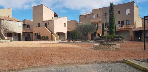 a building with a large yard in front of it at Studio Cosy près du Lac in Sainte-Croix-de-Verdon