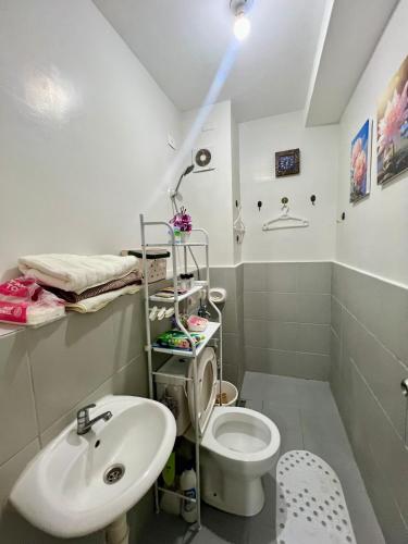 a bathroom with a toilet and a sink at Affordable Condominium in Cebu in Cebu City